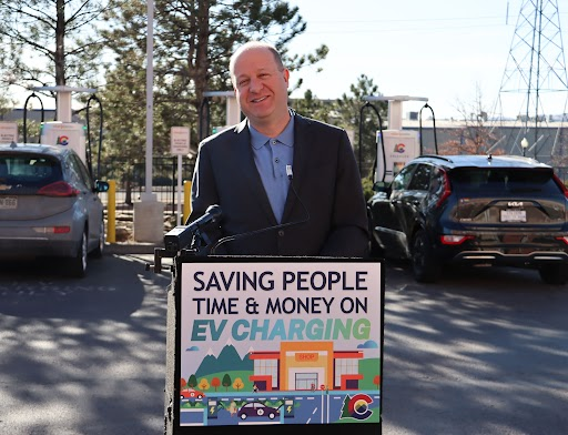 Governor Polis Stands Behind Podium at EV Event